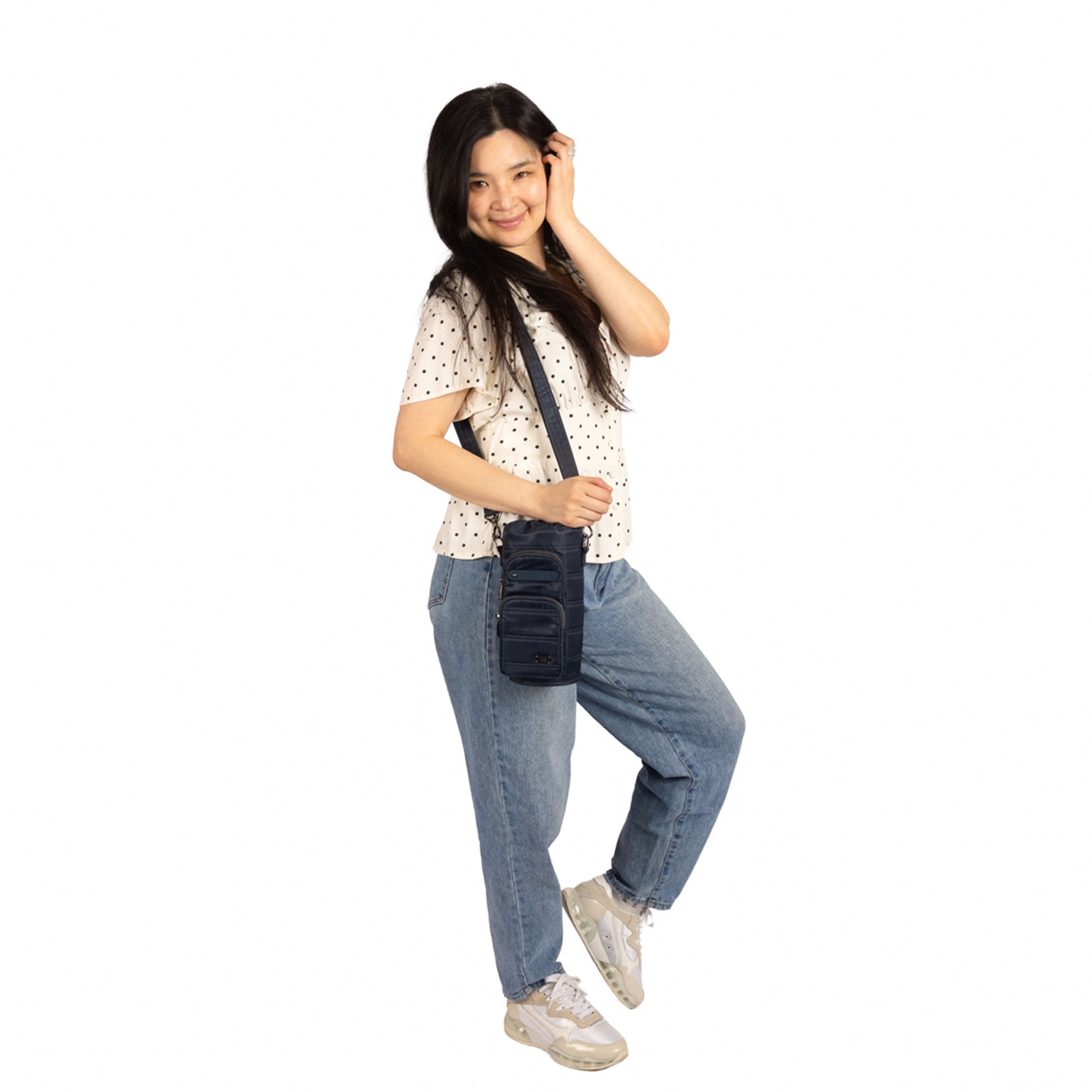 Lug Huggie Wide crossbody water bottle holder with charm bar in indigo, featuring adjustable strap and durable fabric.