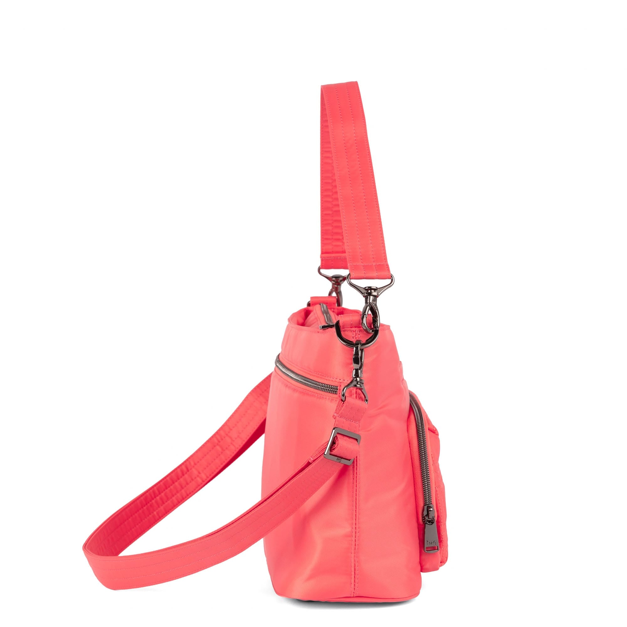 Lug Samba 2 convertible pink grapefruit crossbody bag with adjustable strap and sleek design, shown from an angled view.