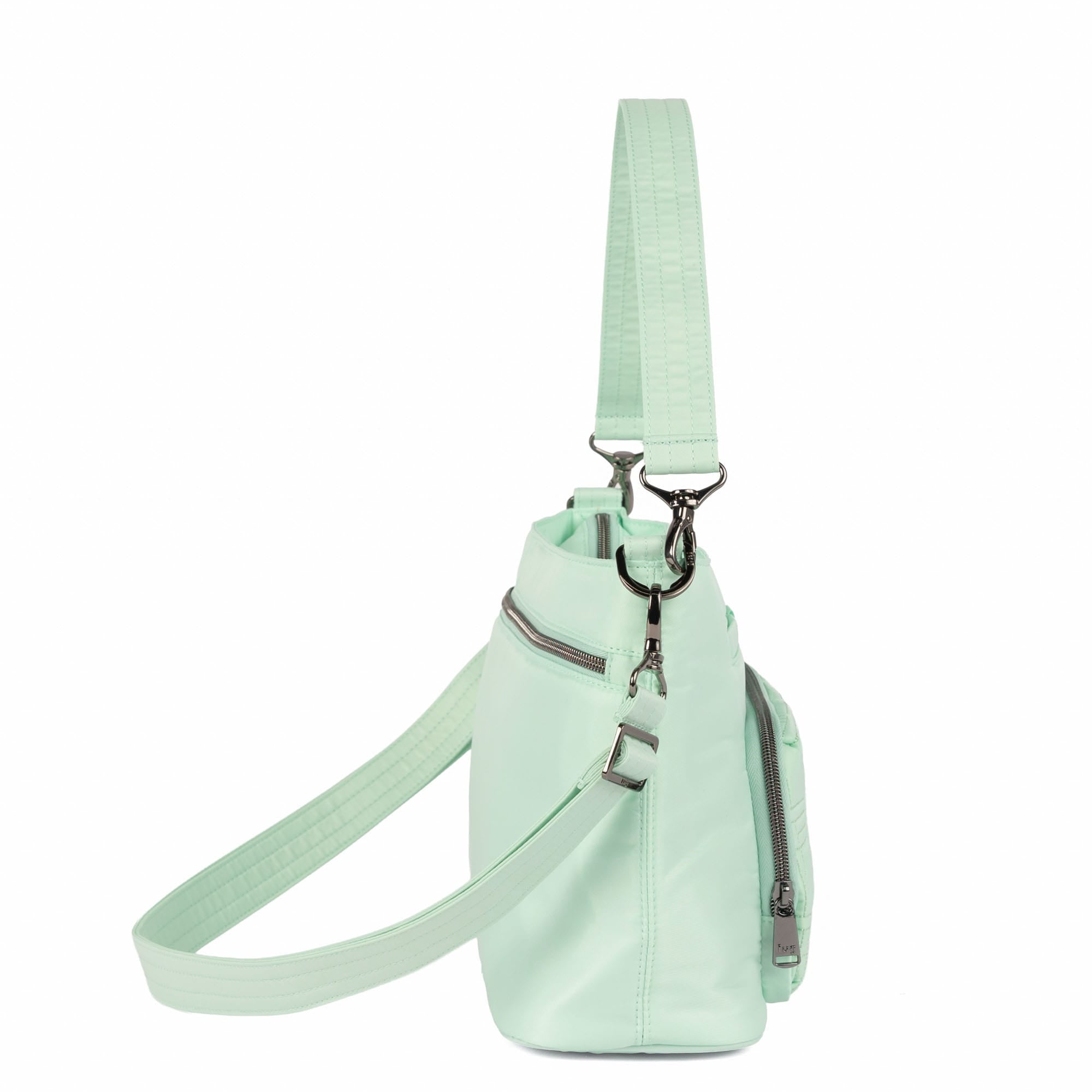 Lug Samba 2 Convertible Crossbody Bag in Mist Green, showing the bag's adjustable strap and sleek design from an angled view.