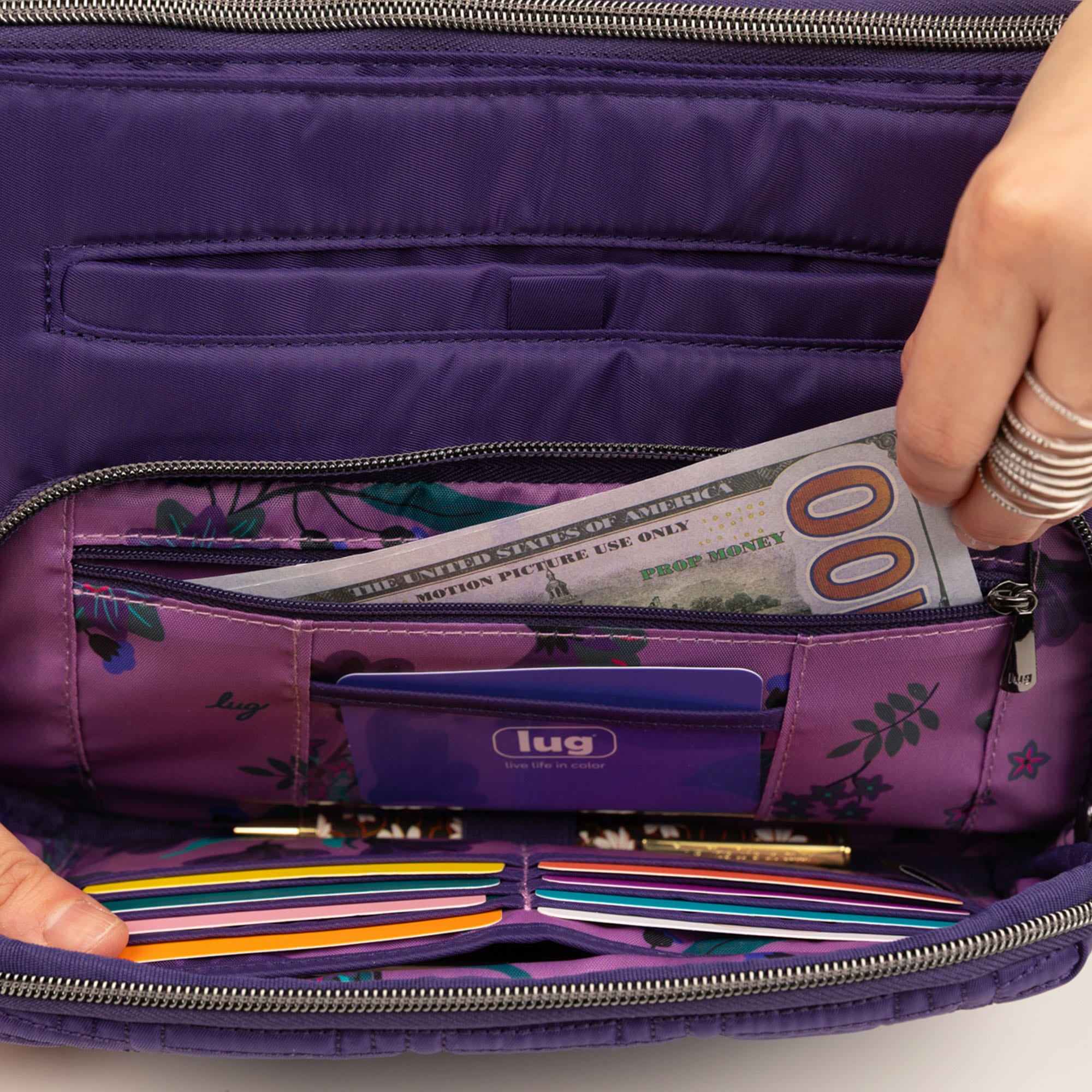 Lug Samba 2 Convertible Crossbody Bag in Concord Purple with adjustable strap, shown in a lifestyle setting.