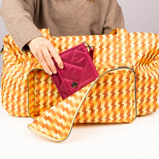 TWiNSAUCE x Lug Bossa Nova 2 Packable Duffel - - 26908_LUGxTWiNSAUCE_BossaNova2_BoltOrange_Lifestyle_01