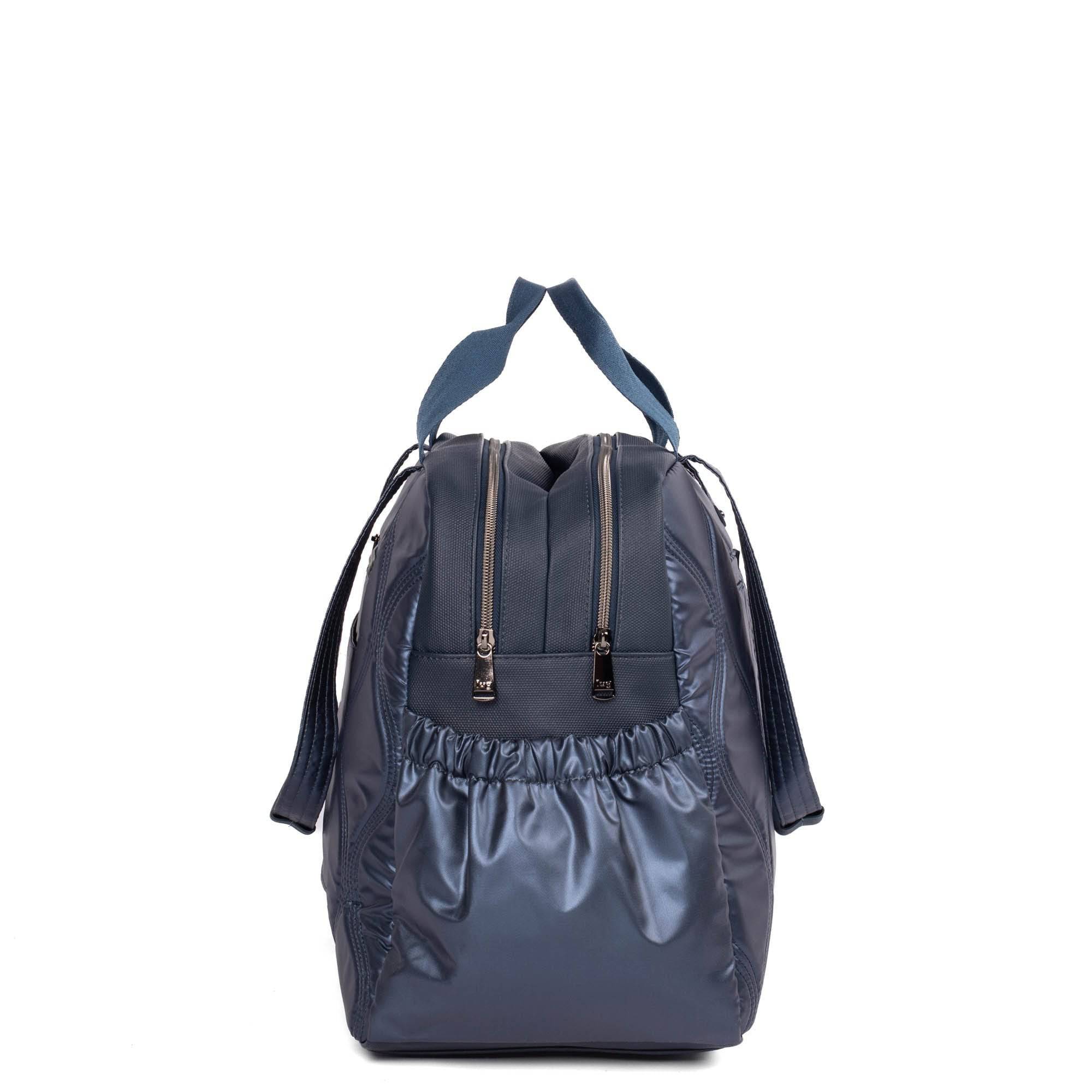 Lug Aviator Carry-All tote bag in metallic indigo with structured design and top handles, ideal for everyday use.