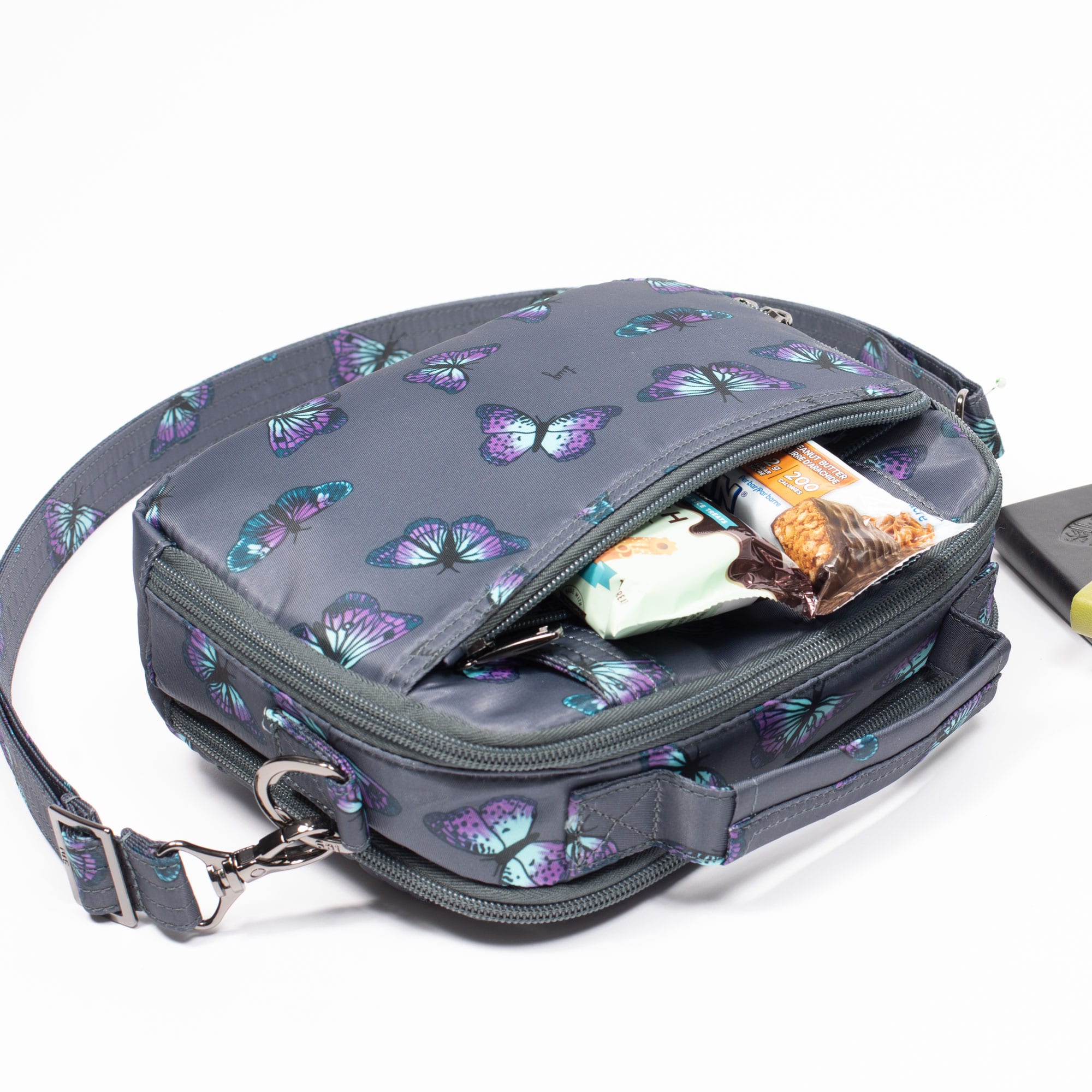 Lug Roundabout XL convertible wallet crossbody bag in black leather, shown worn as a stylish everyday accessory.